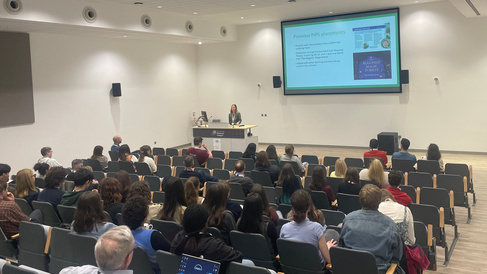 A presentation being given by Dr Raphaella Hull of Cambridge University Botanic Garden to a conference room of PhD students