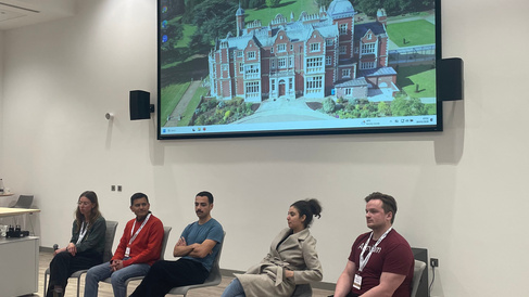 A row of seated speakers answering questions on their presentations